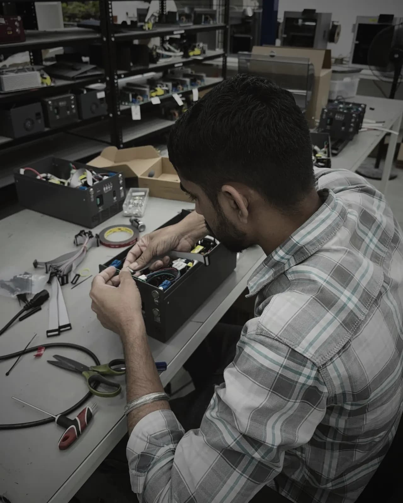 Technician wiring the internals of an AX Charger
