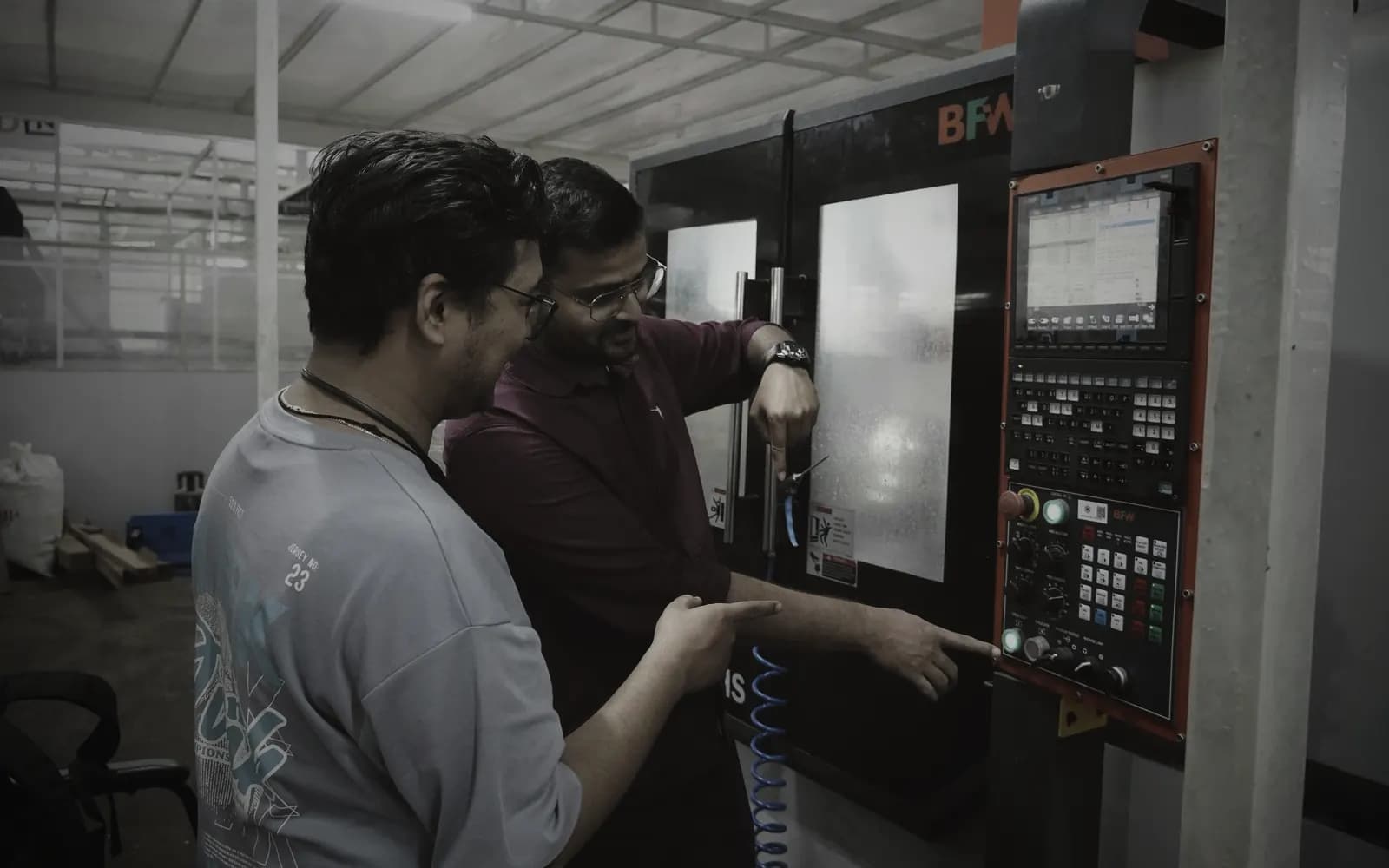 Engineers operating the in-house CNC machining centre