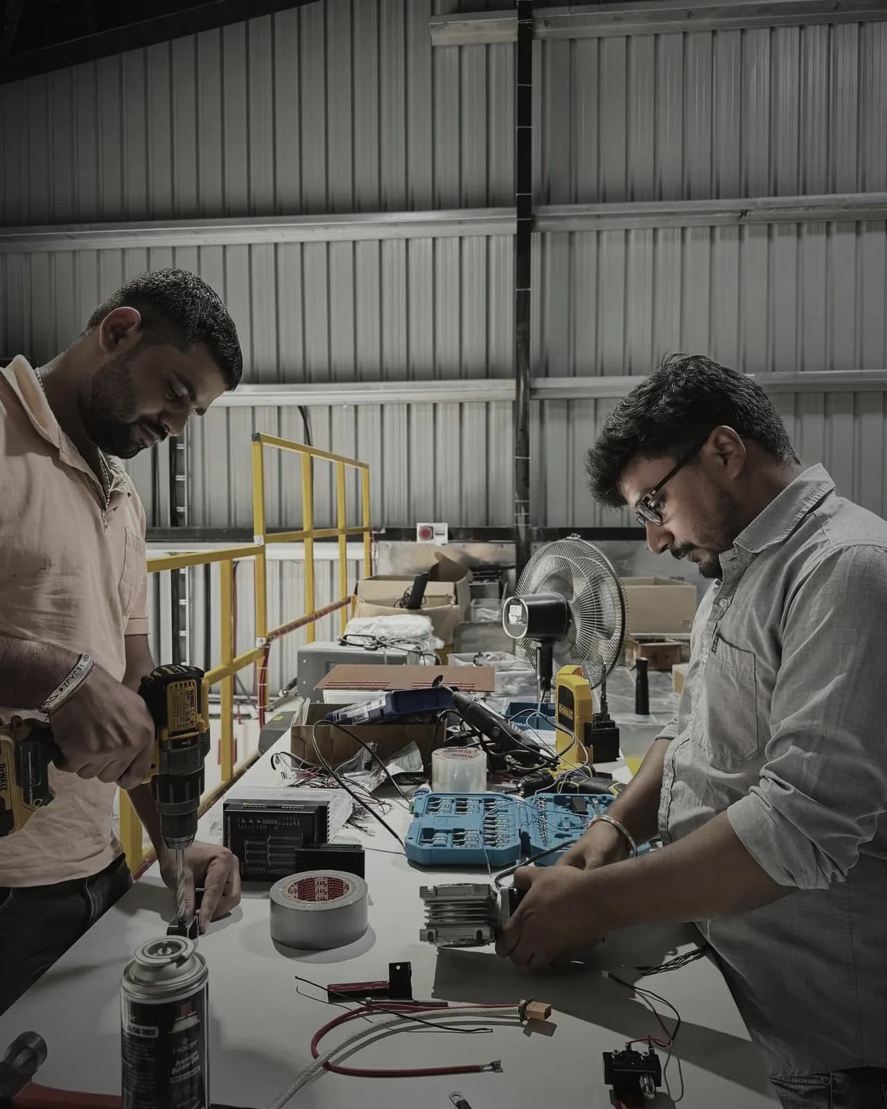 Engineers assembling a motorised dock mechanism in the hangar