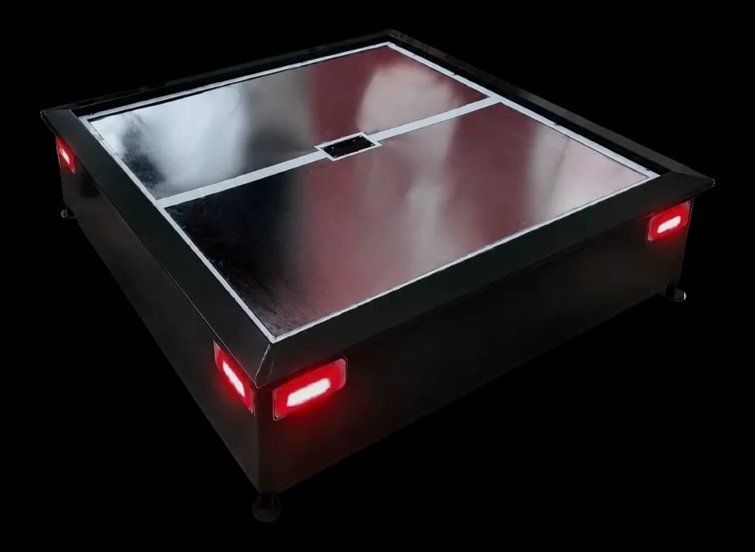 AlgoPAD wireless charging pad with split steel landing surface and red corner status lights